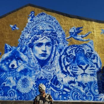 Mural of girl, tiger, fox, and bird on the side of Bourbon on Main