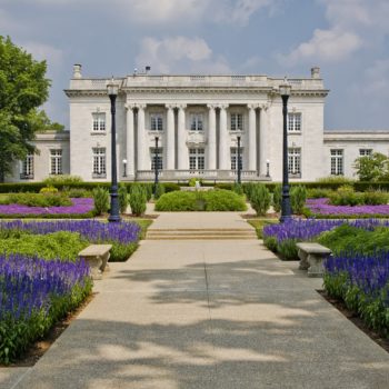 exterior of Governors Mansion surrounded by a garden of purple flowers