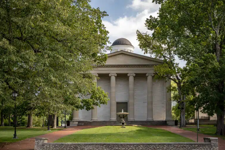 Front exterior of Kentucky's Old State Capitol, a Greek Revival limestone building featuring Greek-inspired stone columns and a grand portico in Frankfort, Kentucky.