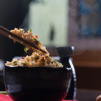 Fried rice in a bowl with chopsticks