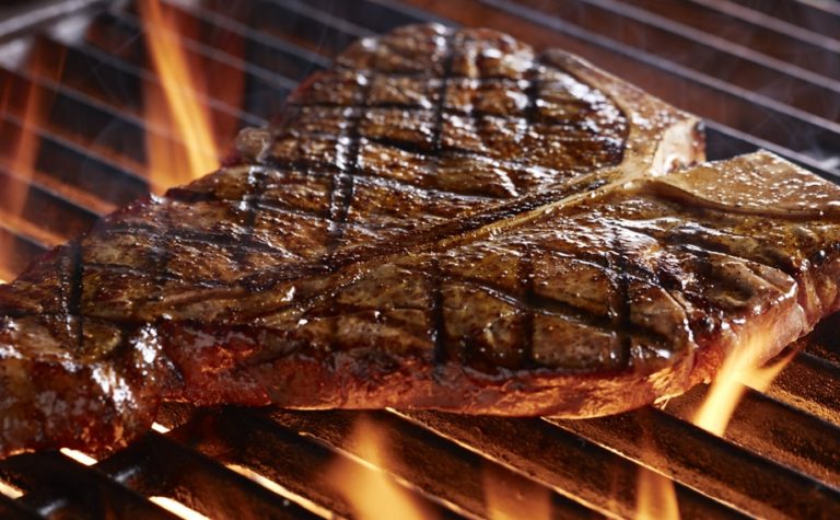 Porterhouse steak over a flaming grill