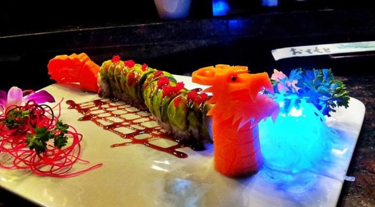 sushi roll on decorated plate, with blue light in forefront