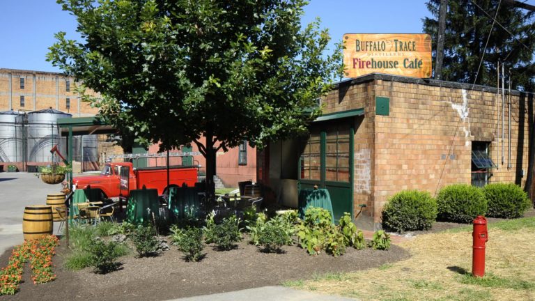 exterior image of the Firehouse Sandwich stop showing brick building and vintage fire truck