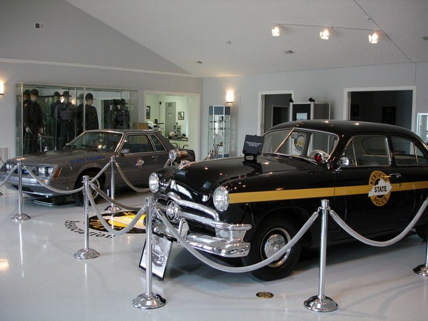 inside museum, old model ky state police car behind ropes
