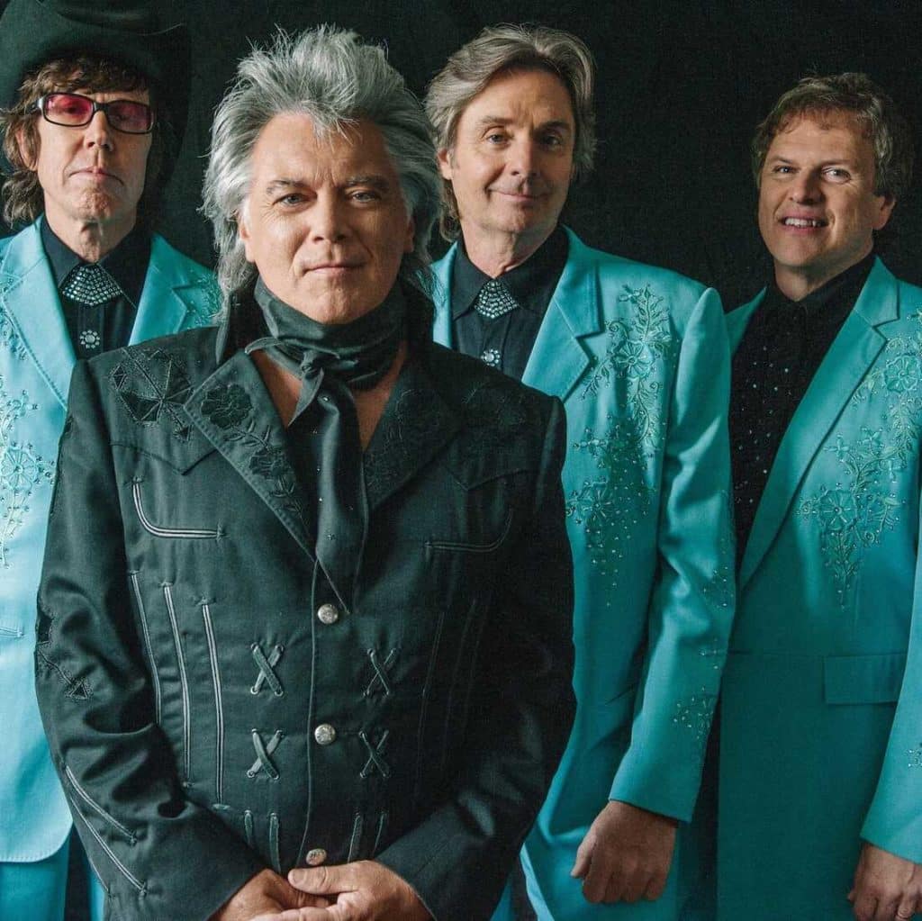 Marty Stuart and His Fabulous Superlatives posing in light blue suits