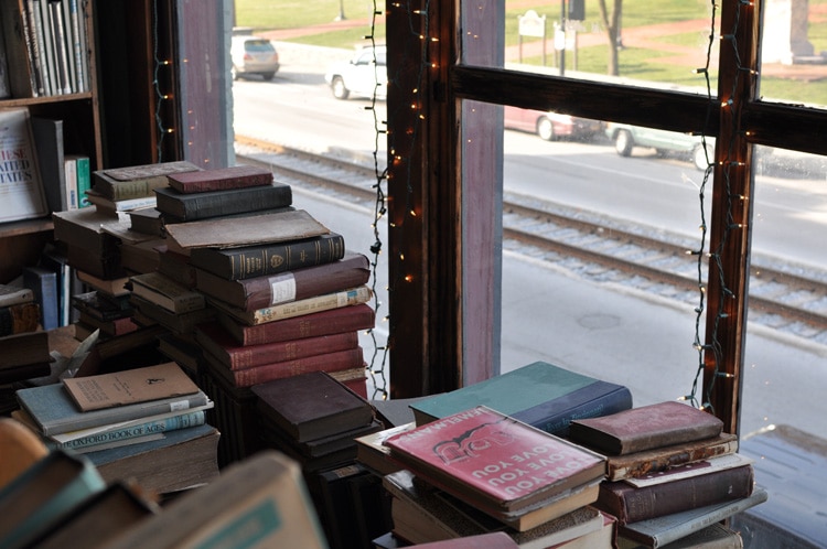 books stacked up in window of attic at Poor Richards